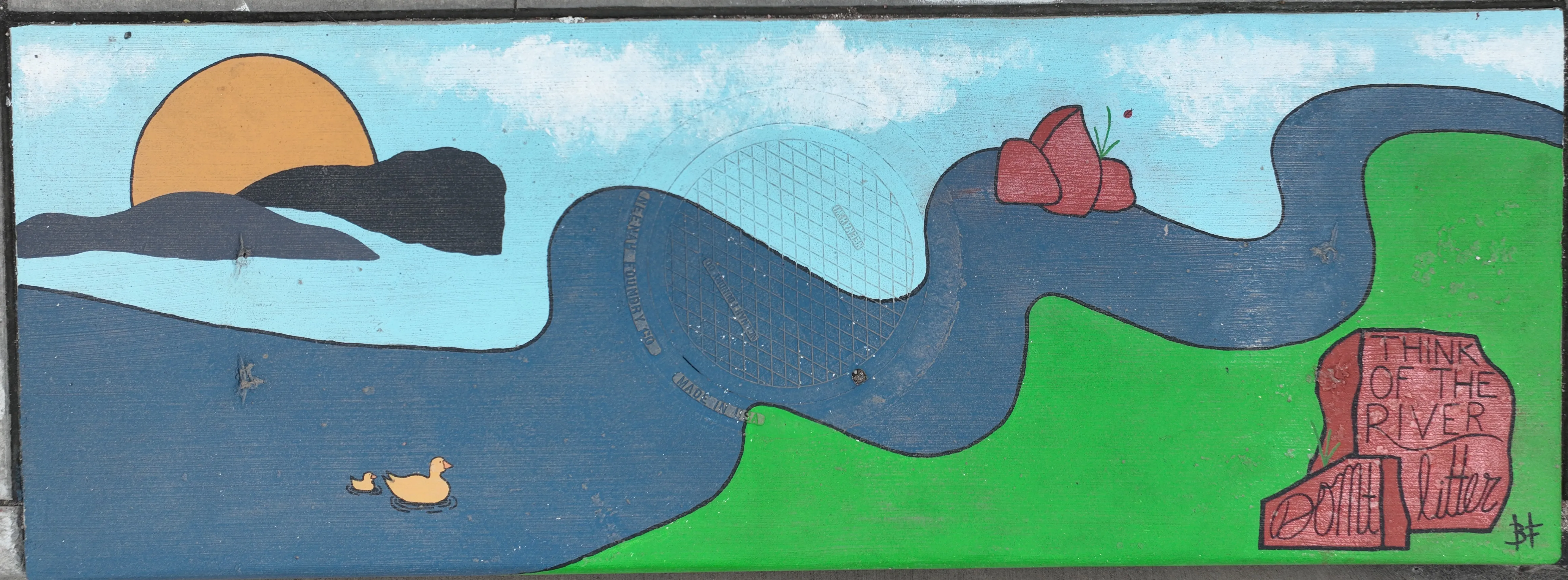 A mural on a storm inlet featuring a dark blue river going from the bottom-left to top-right corner, a sky with a yellow sun, and rocks reading "Think of the River / Don't Litter"