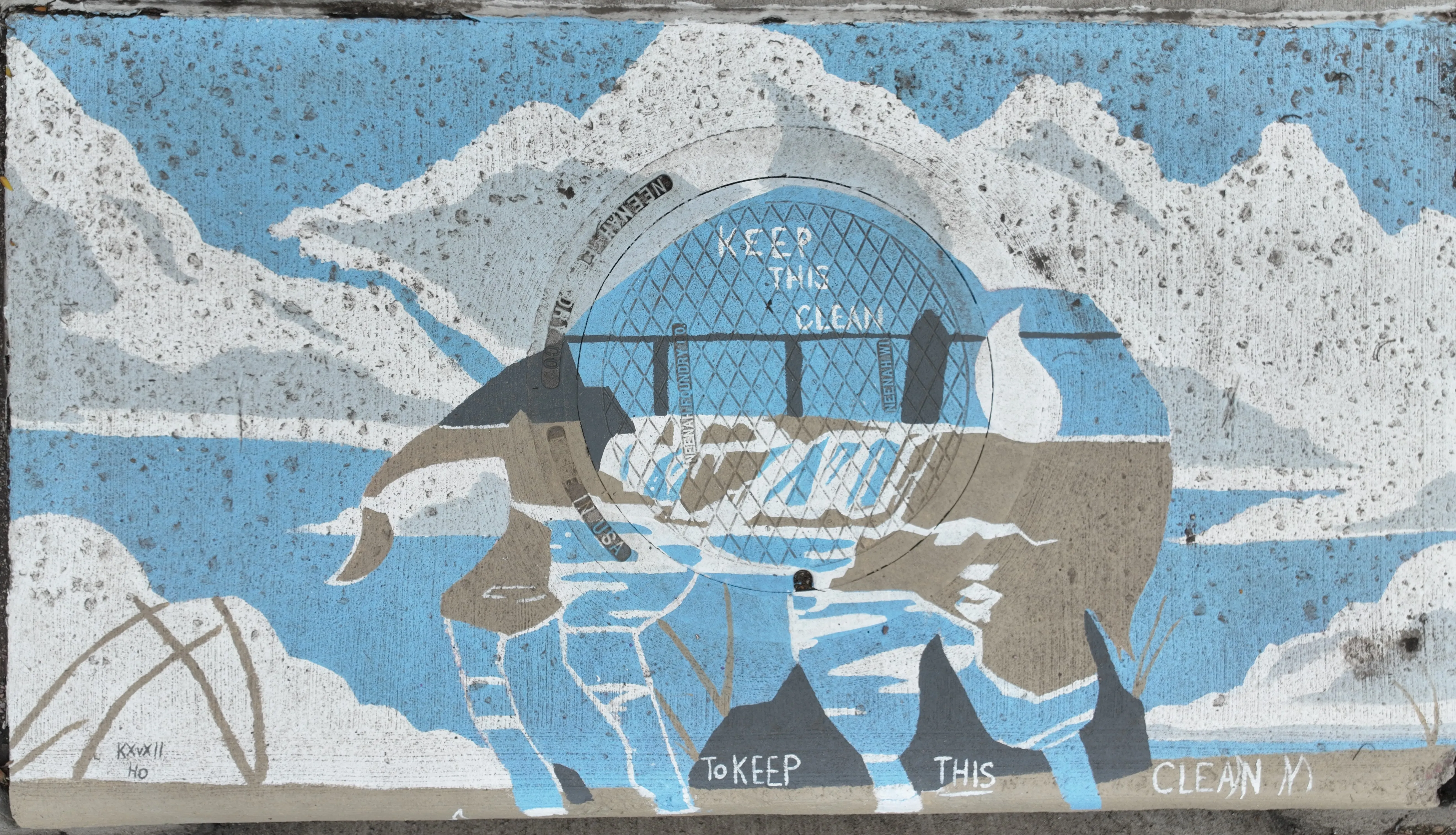 A mural on a storm inlet drain depicting a waterfall and bridge representing falls park, centered on the manhole cover with a sky background.