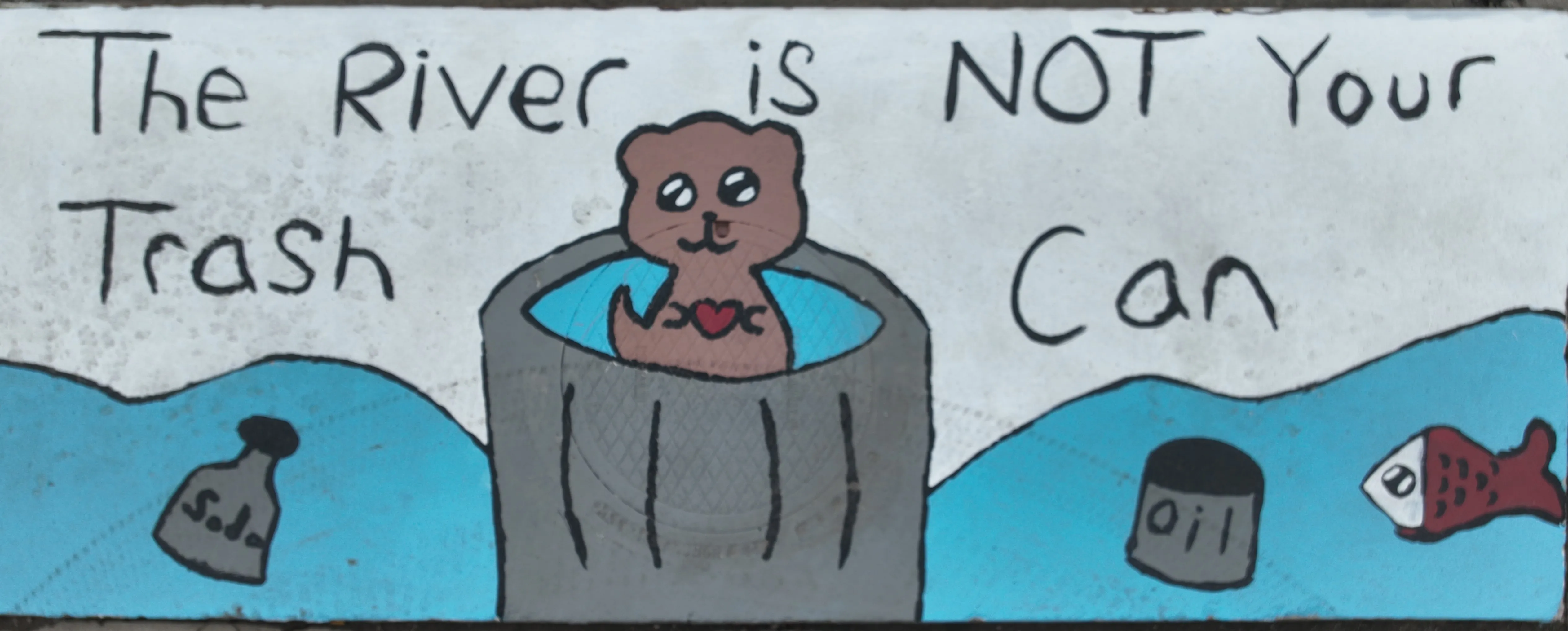 A mural on a stomwater inlet with a river creature centered inside a trash can floating on a river with containers labeled "Soda" and "Oil." Text in the white sky reads "The river is not your trash can"